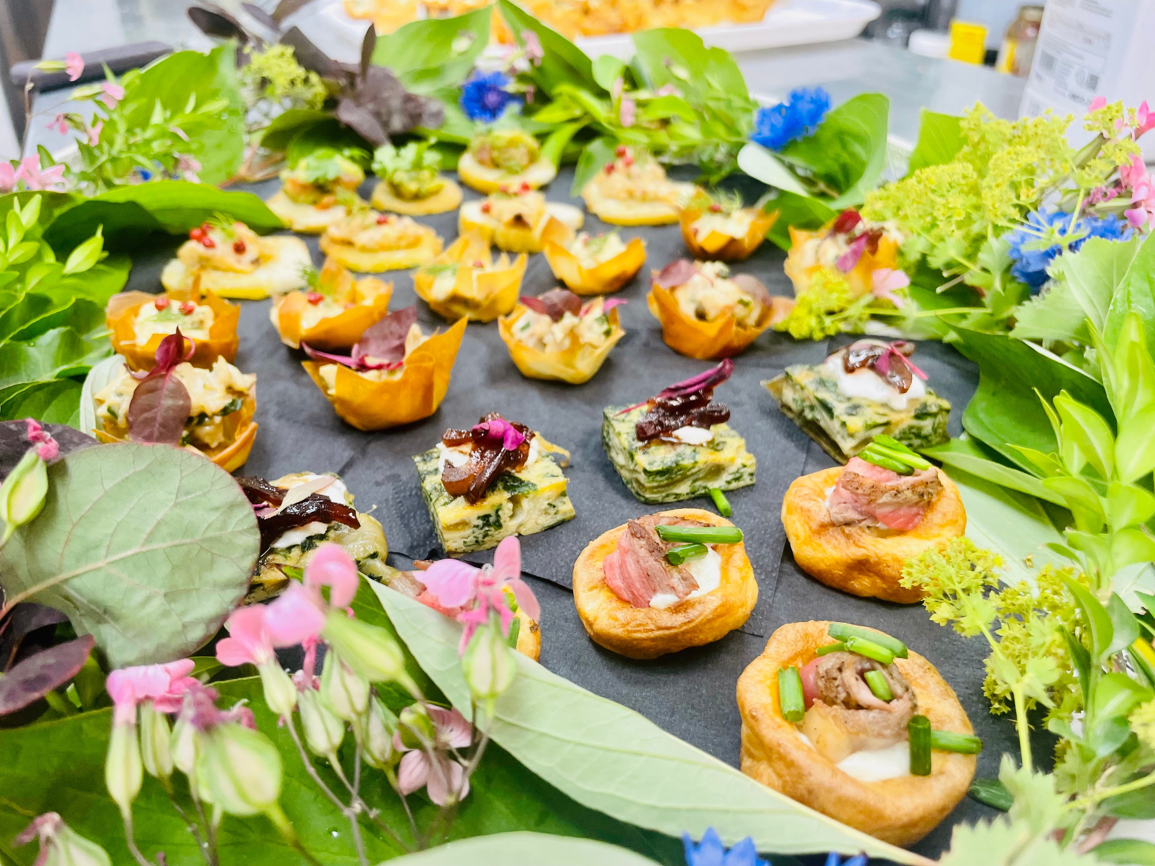 Canapés selection with filo baskets, crostini and edible flowers