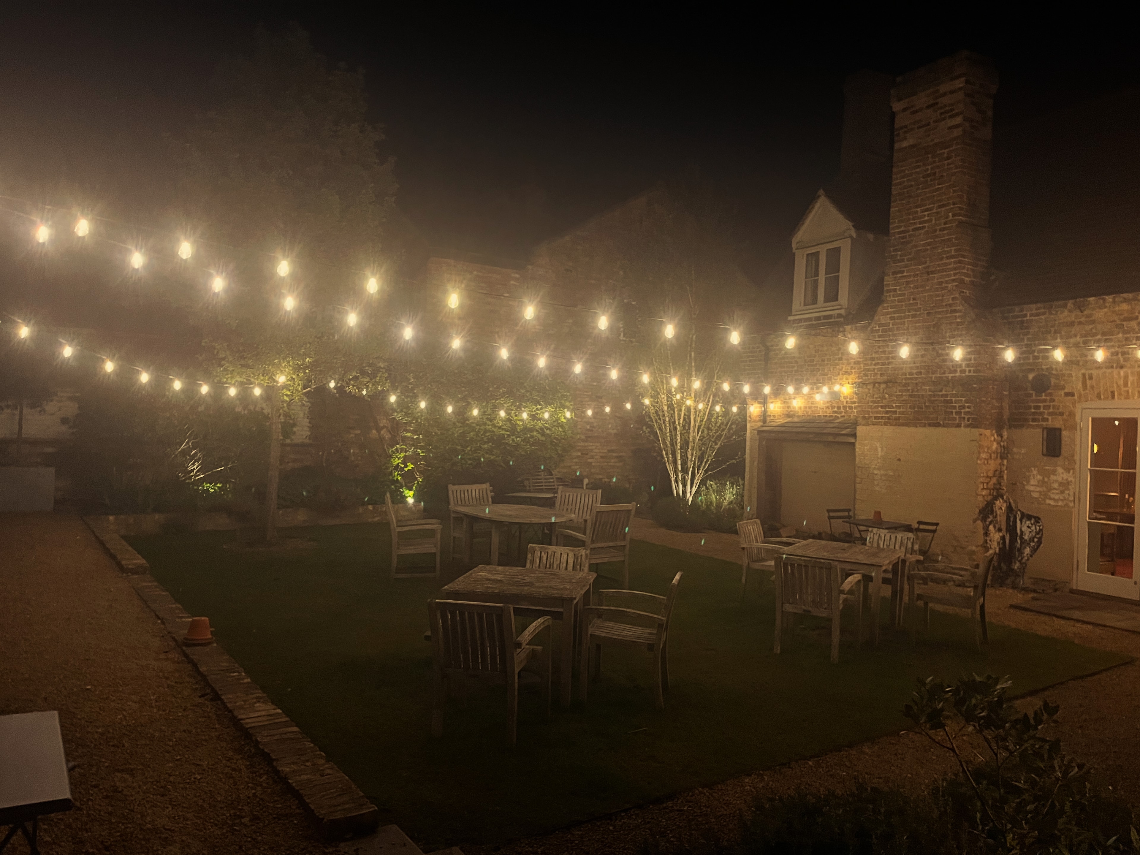 The Red Lion garden at night with festoon lights