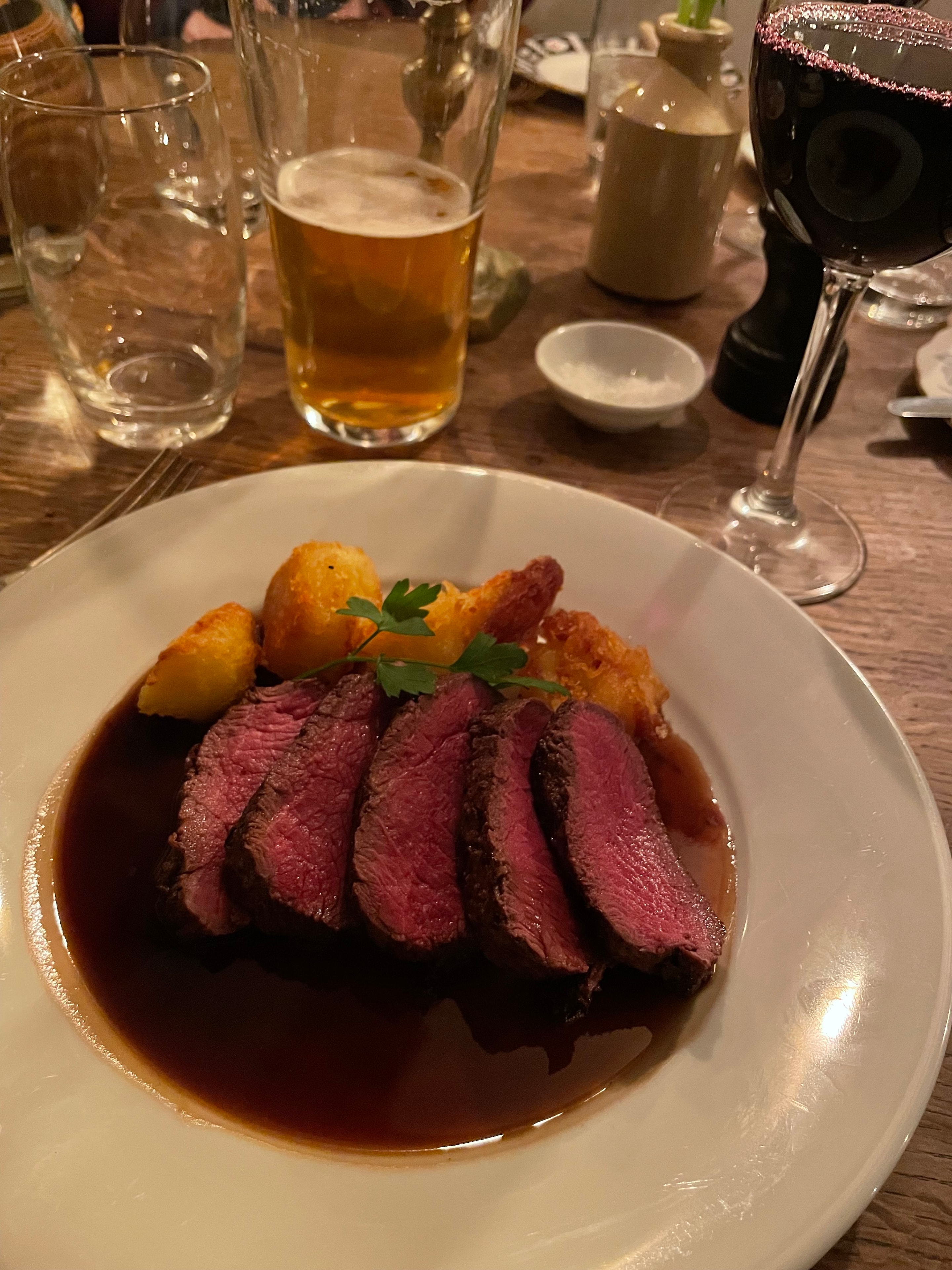 Guest photo: sliced rare roast beef with golden roast potatoes and red wine at The Red Lion, Soham