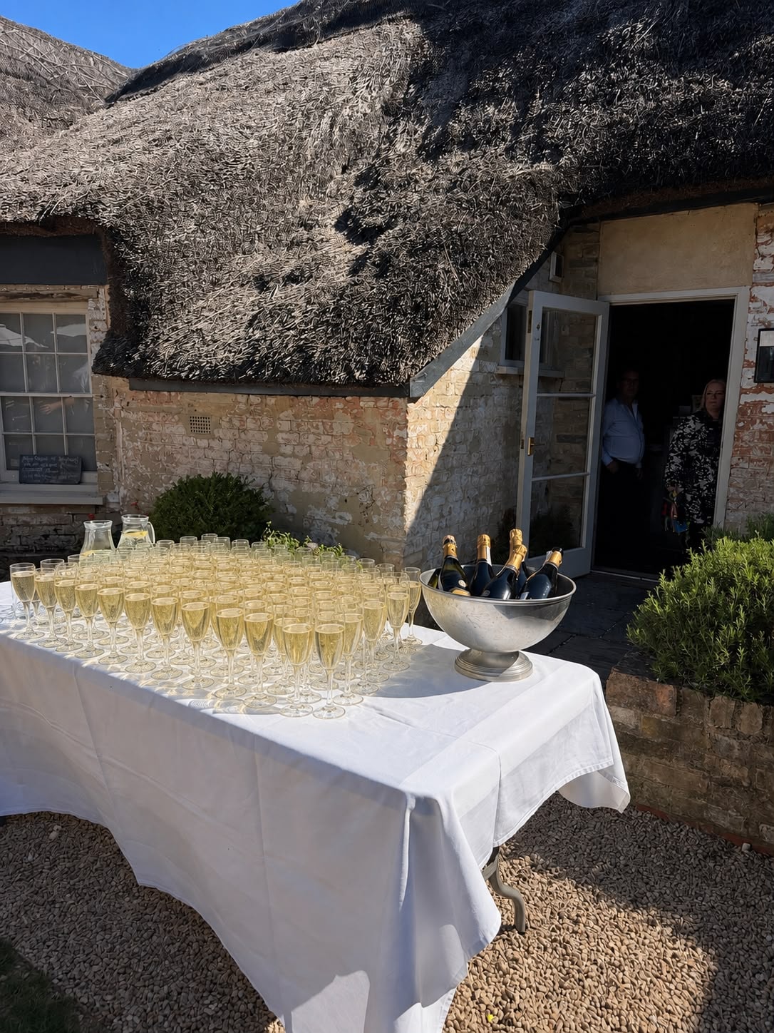 Champagne reception outside the thatched Red Lion building