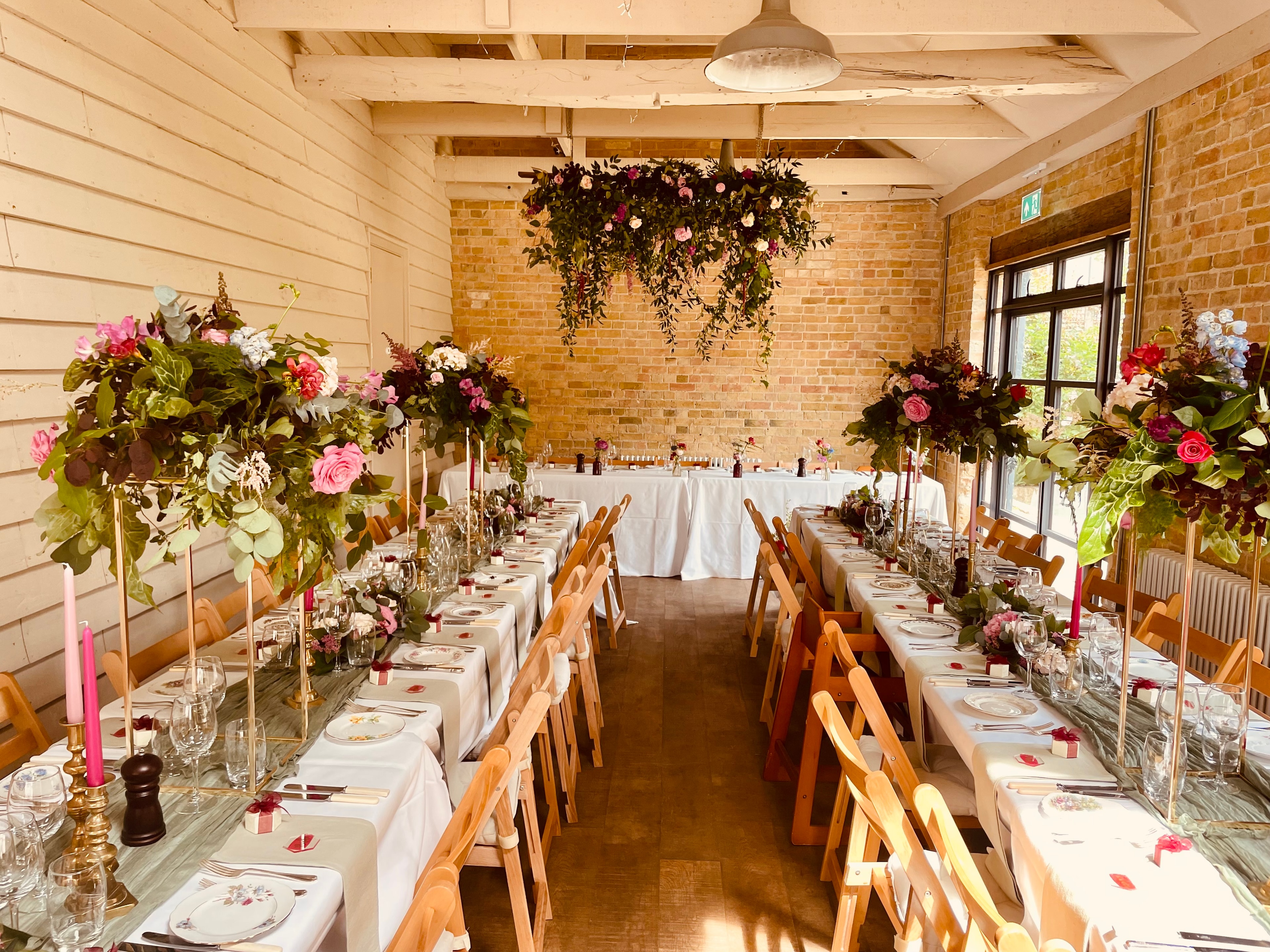 The Coach House decorated with hanging floral arrangements for a wedding