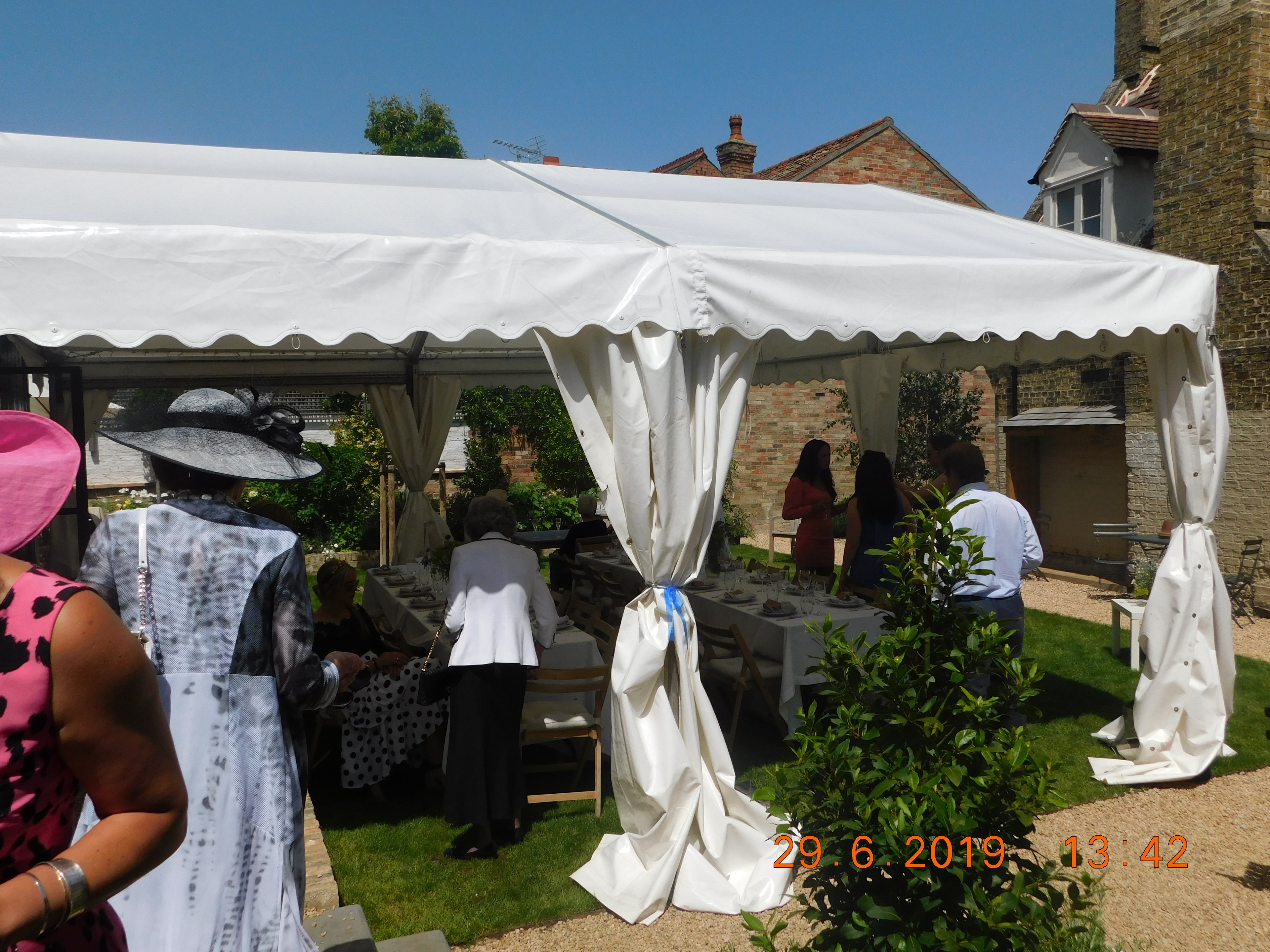 Garden marquee reception at The Red Lion with guests in summer attire