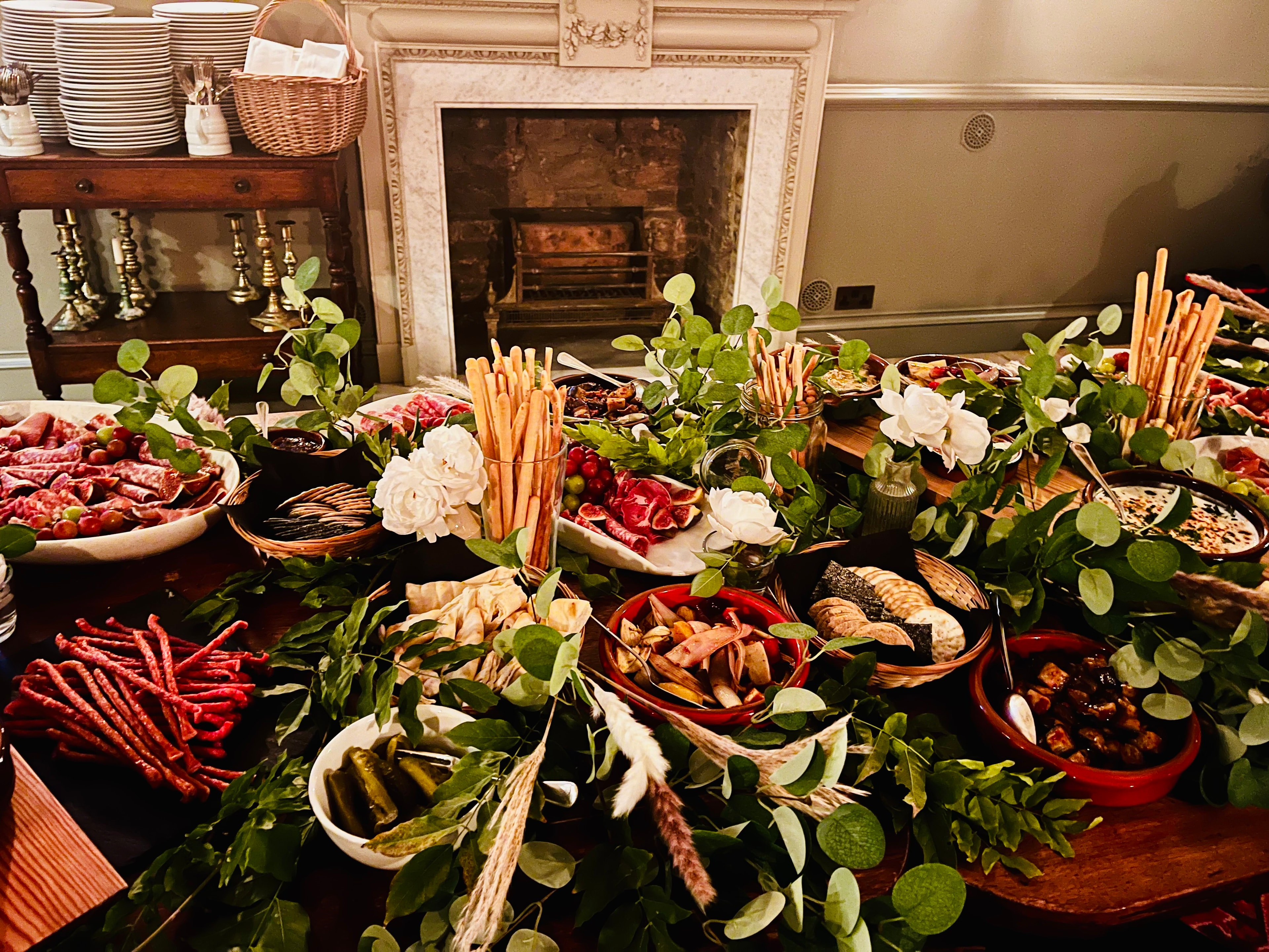 Grazing table with cured meats, breadsticks and white roses at The Red Lion