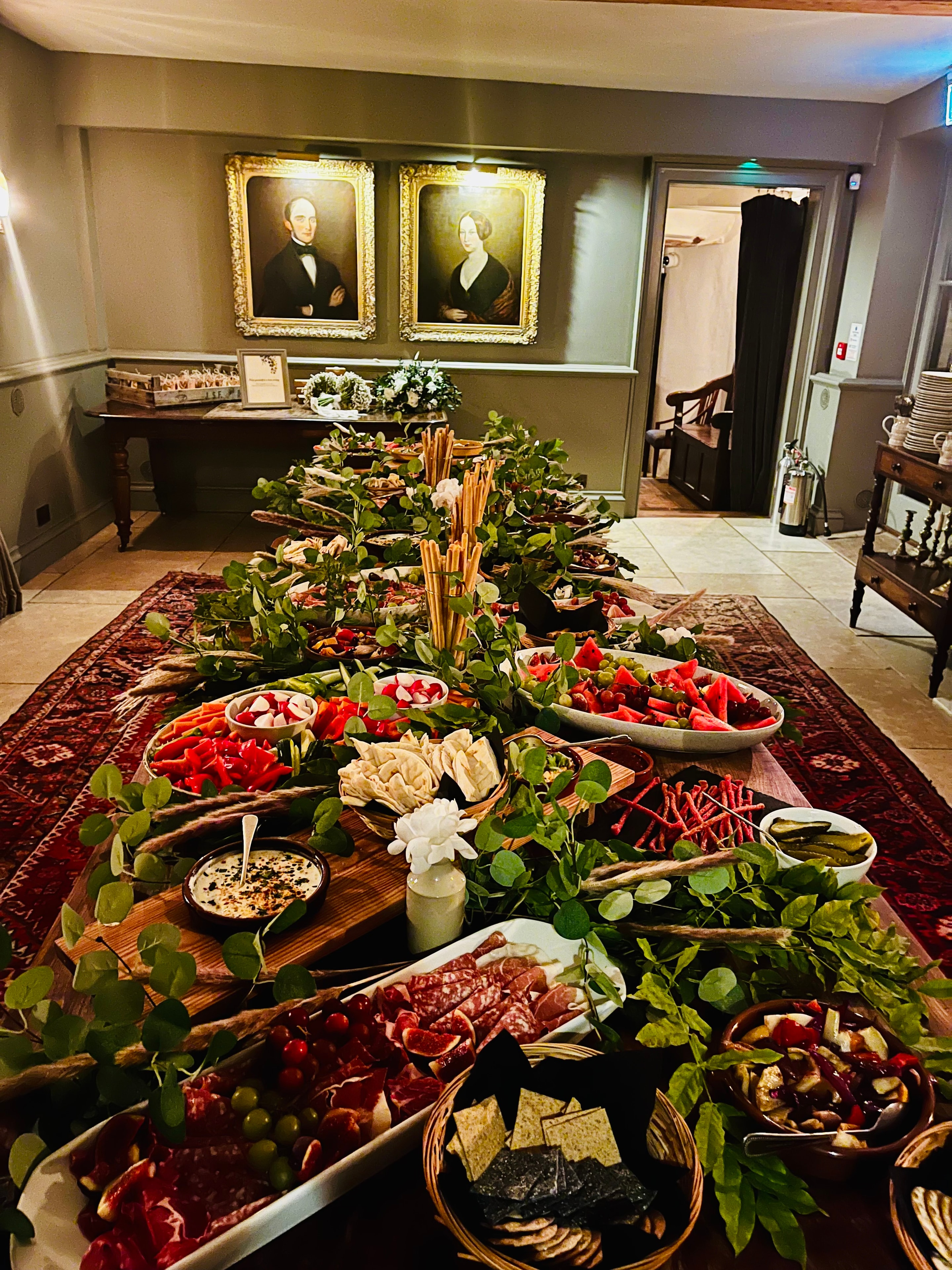 Full grazing table display in The Red Lion dining room with portrait paintings